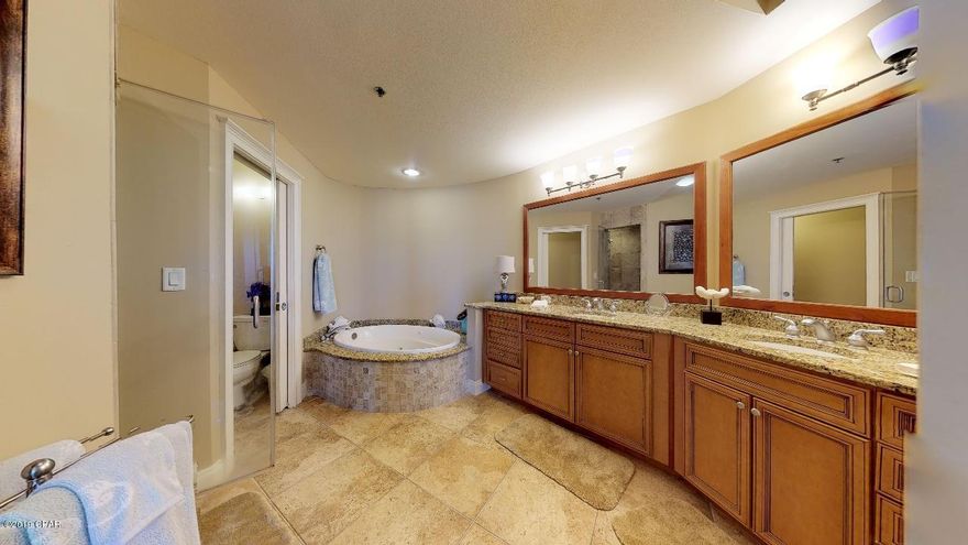 Beautiful ground floor Sunrise condo located waterfront on Lake Carillon and on the condo pool.  This luxury condo boasts a chefs kitchen with large 6 burner Wolf gas range, separate wine refrigerator , warming drawer, separate ice maker,as well as refrigerator/freezer, dishwasher and disposal.  The large master bedroom overlooks the lake with direct access to the patio.  The master bath features double vanities, separate steam shower and large jetted tub. This condo has access to all Carillon Beach amenities including four pools, tennis courts, playgrounds and almost a mile of white sandy beaches.