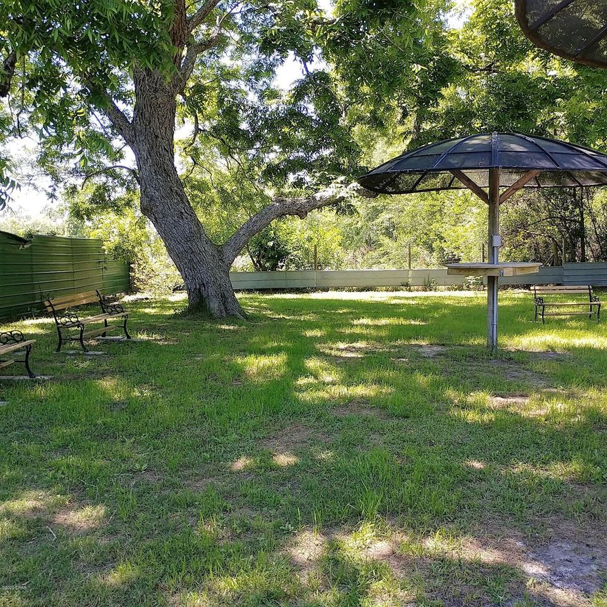 Beautiful lot WITH WATER, SEPTIC TANK AND ELECTRIC already in place and can be used as residential or commercial. Mobile homes, tiny houses, and nice RV's are allowed. Peaceful shaded area that is fenced for privacy and has a butterfly tree, a fig tree, pecan trees, and azaleas. State Road 79 is a direct access to Panama City Beaches. Great place for a food truck and a nice spot for travelers and bikers on their way to/from the beaches to stop, grab a bite to eat and recharge. For an additional fee, there are several nice benches, a fountain, a drink vending machine, two picnic tables, as well as two other smaller tables with electric outlets to charge phones. Seller will consider owner financing with $10,000.00 down payment. There is underground electric, a septic tank in place and lot has city water already set up. The drink vending machine on the property provides a monthly income. Lot has access to commercial fiber optic for phone, tv, and high-speed internet. A small bistro or permanent food truck can be operated on the property as long as a grease trap is added to the septic tank. There was a small mobile home on the lot in the past and a small mobile or tiny house could easily be placed here in addition to a food truck or bistro. There are many possibilities for this lot in this location !!  NOTE: Lot size will be a little larger after survey due to Town of Esto abandoned 2 former alleyways that will be added to the lot size.