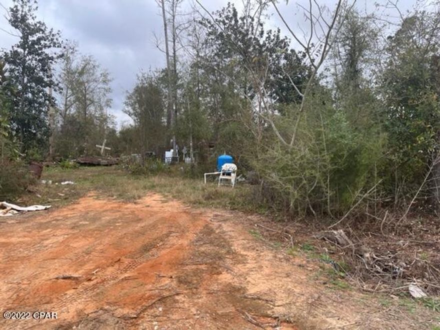 This is an old home place with well and septic.  No restrictions so put your camper, mobile home, tent or even build a home here.  Lot needs to be cleaned up but you have many possibilities and options here.  Location is south of Marianna, west of Altha and north of Panama City.