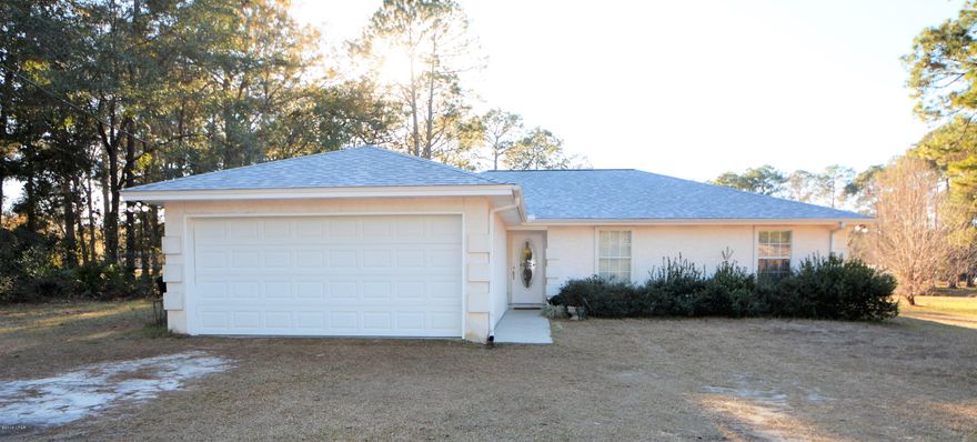 Fantastic three bedroom home on almost one and a half acres, centrally located and available now! This home is situated on the back half of this large, double lot for privacy and quiet. As you enter the home, you will immediately notice the open floor plan as the family room, kitchen and dining area are all open to each other. There is also a second living area beyond the French doors into the den. The den also has a door to the patio behind the home. There is a two car garage and a large laundry room - washer and dryer included! The roof, water heater and dishwasher have all been replaced in the last year, the A/C system is approx. 6 years old and the carpet is brand new. The home is convenient to Tyndall Air Force Base, shopping and our beautiful beaches and water sports. Come see today!