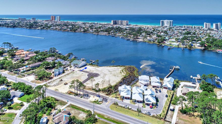 WATERFRONT beautiful 4 Bedroom/4.5 bath home on Grand Lagoon in a gated community.2950 Square feet per builders plans. Home is under construction.  Everything in home is top of the line. Downstairs master, tankless gas hot water heater, large family room upstairs and downstairs, and metal roofs. Decorated by a professional decorator. Community has a pool with outdoor kitchen.  This home comes with a boat slip that will accommodate a 28 foot boat. Walk on your dock and get in your boat for fishing or just a day at Shell Island.  This community is close to restaurants and just a short drive to the beach. Room sizes are approximate. See Plans. Floor plan and elevation listed in documents​​‌​​​​‌​‌​​​​‌​​‌​​​​‌‌ section.