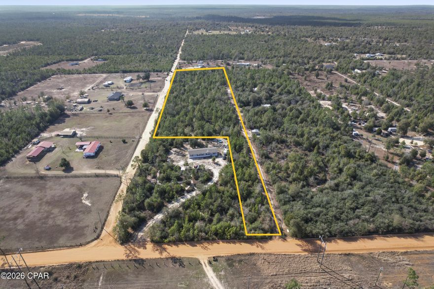 Rare offering of 7.11 Acres spanning Singer  Road and Peacock Circle. Expansive Wooded lot with some walking trails carved out.  In place is one ''Mill Shed'' building, (no heating, no cooling).  Imagine the possibilities.  This peaceful country setting in Youngstown offers privacy, while not a far drive from Lynn Haven, Panama City and even the Beaches of the Gulf coast!