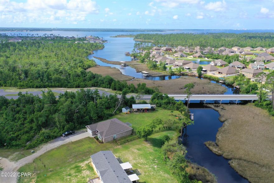 Welcome to Lot 28 Hickory Bluff, named for the trees and high and dry land, this is a very nice building lot right on the water and  ready for a new construction or mobile home.   This property has potential Bay/Gulf Access with small boat or waverunner, buyer to verify if important. Surrounded by new homes and a short distance to Fanning Bayou, fishing, boat ramp and just a few miles from Lynn Haven. The lot has with no association fees so bring your boat, RV, build a pole bar or workshop. Peaceful, quiet and ready to go today! Many other lots to choose from, Non water front start at $19,500, choose from any of the 50 lots we have for sale in Hickory Bluff community! Call for additional details.