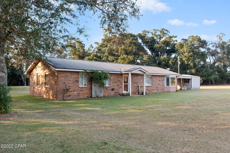 BEAUTIFUL COUNTRY HOME on over 2 acres with an amazing view!  This move-in ready home is situated on a paved road & features so many extras.  The home is in immaculate condition, has an extra family room that could be used as a 4th bedroom, a 2 car attached carport with a 10 X 20 Metal Shed hooked to it, a 16 X 48 Pole Barn with 50 Amp breaker for RV & dump station near the home, a 16 X 20 Work Shop for a lawn mower & tools & the septic has 3 drain fields.  You'll enjoy morning coffee in the screened-in large Florida Room on the back of house.  Beautiful hardwood flooring, tile counter-tops & back splash in the kitchen, a walk-in cloest in the master bedroom & an upgraded master bathroom with a walk-in tile shower & heated towel rack are some of the most appealing features of this home.