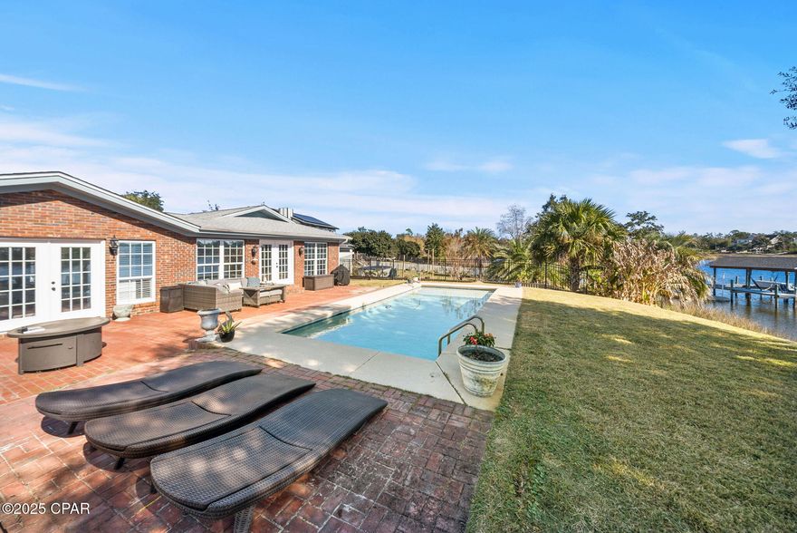 Welcome to this beautifully renovated 4-bedroom, 2-bath waterfront home offering the perfect blend of modern updates, coastal charm, and true Gulf-access living. With 100 feet of water frontage, a private boat dock, and a boat lift, this property is ideal for anyone who wants to enjoy life on the water. 

Step inside to find updated flooring, fresh interior paint, and a bright, airy layout filled with coastal vibes. The kitchen has been recently upgraded with modern cabinets, sleek countertops, and newer appliances, delivering both style and function.

The spacious master suite features a generous walk-in closet and plenty of natural light, creating a peaceful retreat. Additional highlights include newer lighting throughout, making every space feel refreshed and inviting.

Outside, enjoy your own backyard oasis with an inground pool installed in 2022, perfect for entertaining, relaxing, or cooling off after a day on the water.

Located close to shopping, restaurants, schools, churches, and Tyndall AFB, this home offers incredible convenience while providing the coastal lifestyle buyers are searching for.

Move-in ready, updated, and on the water, this one truly has it all!