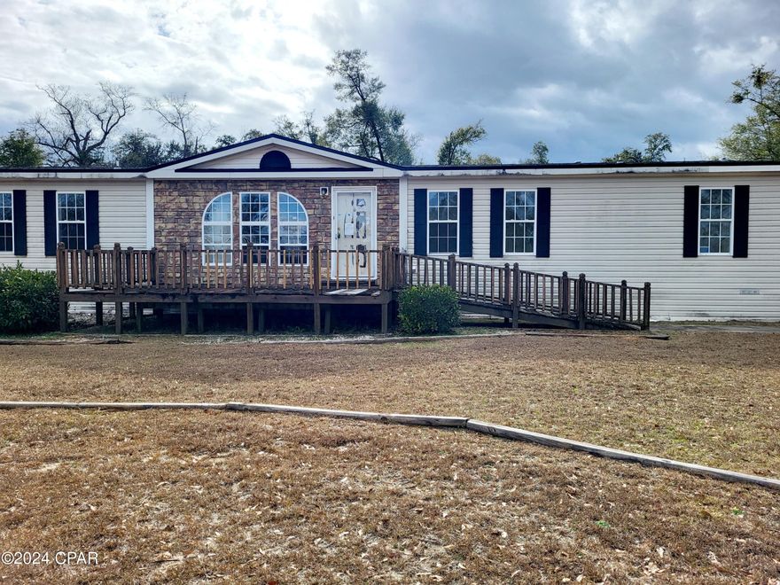 Country Living at its Best!  10 Acres that are cleared, fenced and ready for your horses or cows!  Have your own little Farm!  Close to Marianna, Walmart, Hospital, Chipola College, This 3/2 Manufactured Home has 2,304 Sq Feet of Living Space, plus a 2 car carport and a large screened patio for enjoying the outside!  Just a few updates and renovations to complete to make this your forever home.  Roof and HVAC Systems appear to be less than 3 yrs old.   Call and request a showing of this home.