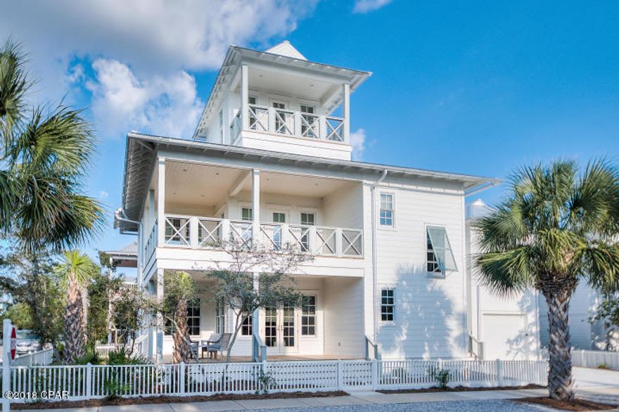 This recently built three story home features four bedrooms that will accommodate up to ten guests in the gated community of Carillon Beach located on the Gulf of Mexico. The open floor plan on first floor, which incorporates kitchen dining and living room, offers the perfect setting for family gatherings after spending a day on the sugar white sand beaches and turquoise waters. A large L-shaped sectional sofa provides generous seating, as well as the dining table with seating for eight. The gourmet chef's kitchen is complete with commercial style appliances and highlighted by a honed marble island with bar stools. A half bath and separate laundry room are located down a hallway off the kitchen.