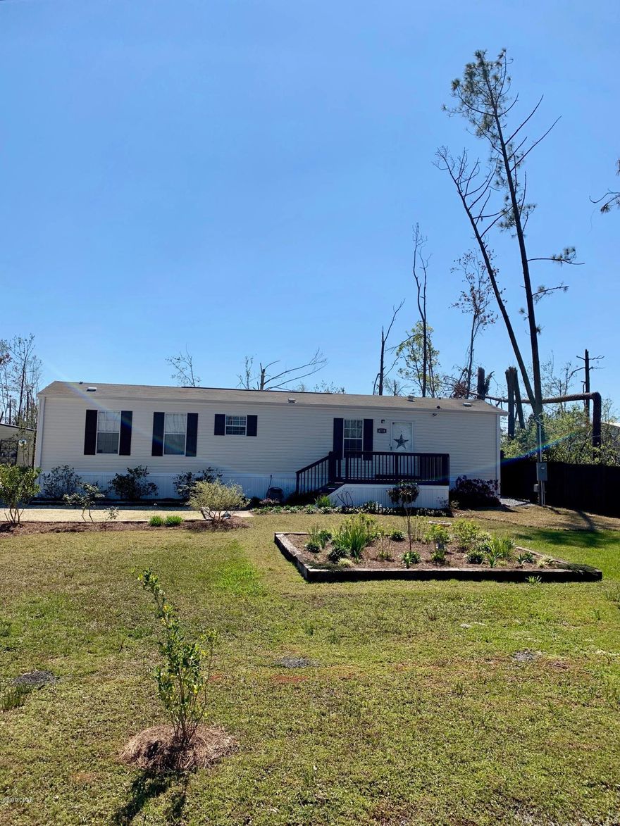 CURRENTLY UNDER CONTRACT, SELLER ACCEPTING BACKUP OFFERS Affordable, immaculate, move in ready home on a little over a half acre!  This one won't be here long - check out this great home already converted from a mobile home to real property.  This 2012 home has two bedrooms and two baths and is all electric, on public water and sewer!  The bedrooms are on opposite sides of the home.  The great room is open to the kitchen and dining area.  The washer and dryer stay in the laundry room along with all appliances including the refrigerator (with ice-maker) and microwave).  The master has an en suite bath with a double vanity, and a shower with two benches built in.  His and hers closets make for good storage in the master as well. 

There is an 8x12 front porch and an 18x20 covered deck in the back.  There are manicured flower beds showing the pride of ownership, beautiful even after the Hurricane.  Two out buildings both have power, and automatic dusk to dawn lighting.  The front porch has this lighting as well.  Other features - the home has whole house ventilation - even when the air conditioner is off, there is air circulating through the vents above the doors - this can really save on your power bill.  Something you can't see - there is a "pump grinder" which grinds waste and pumps to the sewer system - all underground.  
Exclusions - Draperies and rods in Master Bedroom, Living Room, and Guest Bedroom DO NOT CONVEY.  All blinds and other curtains do stay for the buyer.  
If this sounds like the home for you - please call your Realtor and get in to see it before it's gone!