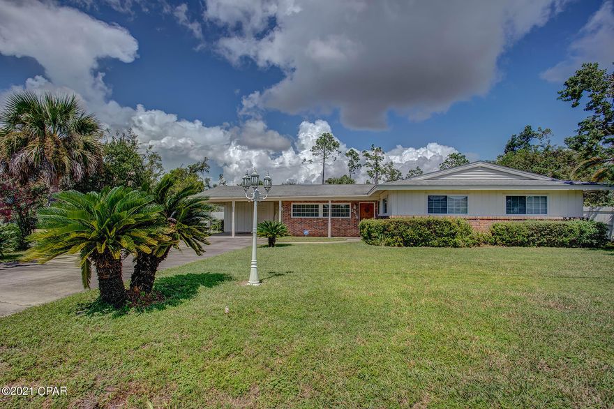 Call for a appointment to view this lovely ranch style home. Located in Historic St Andrews part of the desirable Cove area. Be in the center of it all, convenient to downtown shopping, restaurants, schools and much more. Enjoy this lovely home, featuring a large living room with hardwood floor, fireplace, accented with beamed ceiling, large kitchen area, dining room, 3 bedroom, 2 full bathrooms with lots of storage. Additional storage room/workshop connected to the covered carport. Enjoy your brick patio, viewing your over size lot which connects by gate to the back street. Great for a pool, RV storage or boat. Good investment opportunity. The house is freshly painted with current upgrades and ready to move in, or to add your touches to make it your home .This will not last long.