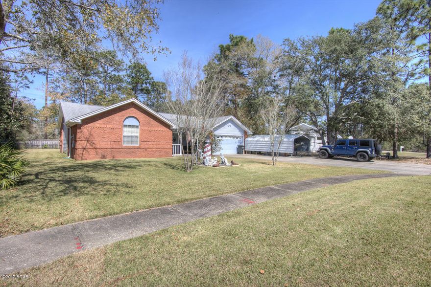 Heritage Woods-  This quality built and well cared for brick home just 15 minutes to Tyndall AFB is a gem. This home features ceramic tile throughout the Foyer, Living Room, and Kitchen. High ceilings in the Living room and Vaulted ceiling in bedroom, as well as a Tray ceiling in the Master Bedroom which has two (2) very large walk-in closets and full bath.The ample Kitchen has a beautiful LARGE Pantry, Livingstone counter tops with plenty of cupboard space and very nice Maytag and Kenmore appliances. Separate laundry room just off the kitchen and a large Florida Room, Spacious 2 car garage with finished walls.New carpet installed in all bedrooms in 2011. 30 year Roof Singles installed in 2003. Sprinkler system with well and pump and a beautiful, well maintained yard. This is a must see.