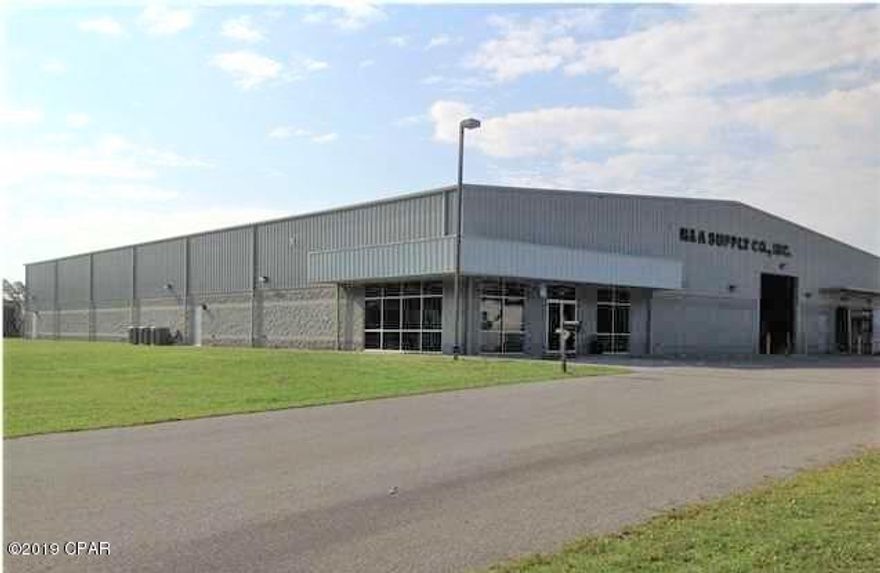 21,250 sq. ft. building with 2.16 acres in Lynn Haven Industrial Park. Currently leased to Jensen USA who plans to vacate at the end of this year when their expansion across the street is completed. The building includes warehouse, office, and showroom space. The showroom and office space measures +/- 3,200 sq. ft. with large showroom, 3 offices, break room, ADA restrooms and large training area. The landlord could add an additional 9,500 sq. ft. if needed. The ceiling height is 20 ft. clear at the eaves and 23 ft. at the center. Two dock-height doors approx. 8' x 9' each and one 14' x 14' street-level door. 3-Phase, 480 Amp service. Building is concrete block and steel frame and had minor damage from Hurricane Michael that was repaired immediately.