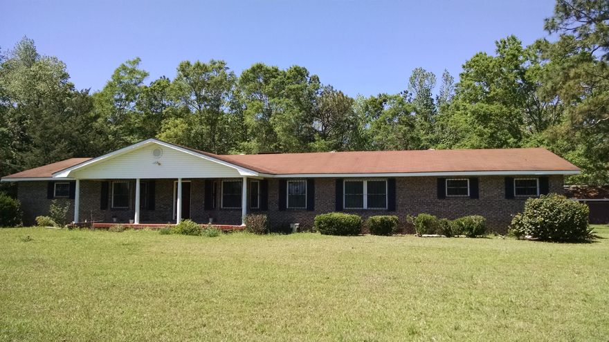 Large brick home on 13 acres. If you have a big family this is the place for you. With 6 bedrooms and 3 bathrooms has room to spare. House sits way back off the road behind a large beautiful pond. Well landscaped yard with some nice shade trees. Has a detached double car garage, large front porch and covered back patio. There is another house on the property near highway, presently used for storage. Has split system for AC recently upgraded to a energy efficient Trane AC unit. Home has a fireplace with gas log burner. Large kitchen with updated appliances. To many details to list, make an appointment to see today.