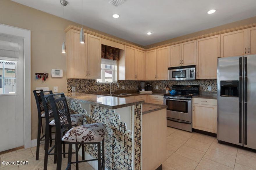 Updated, high-end 2 bedroom, 2.5 bath beach cottage perfect for full-time home or investment. Short walk to beach access (less than 5 minutes), just across Thomas Drive. Granite countertops, stainless steel appliances, mosaic backsplash, gas fireplace for those chilly beach nights, balconies on bottom and upper floor to catch the cool Gulf breeze and community pool for lounging and relaxing. This perfect property is waiting for YOU.