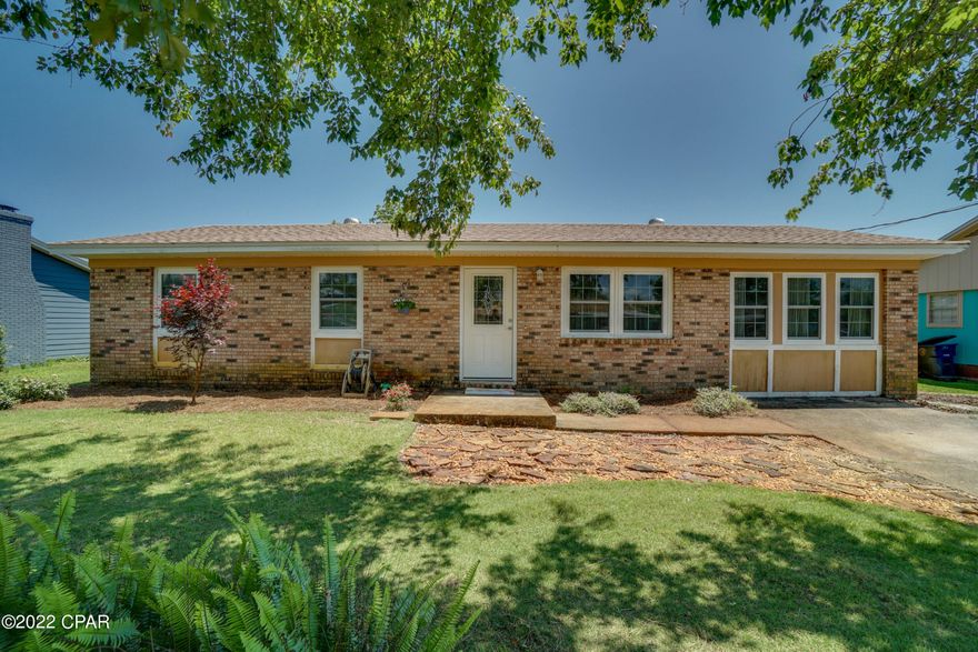 Environmentalists and Nature lovers who want to live in town this a great home for you. This home is located just off Beck Ave and 23rd St close to restaurants, shopping, Downtown St Andrews and the marina and just a short drive to the beach. The brick home features a beautifully landscaped yard complete with irrigation pump/system, a huge workshop with electricity that offers easy access and plenty of storage or that would make a great ''man cave'', a 50 amp outlet for your RV or camper, a beautiful open deck to sip cold beverages and host weekend barbaques for friends and family while over looking the large backyard and flower garden. The new solar panels will literally save you thousands of dollars a year. The sellers average electric bill is $23.00 a month. The yard has plenty of space to add a pool. Also featured is an outdoor shower just off the master bedroom to easily bathe your furry friends. This floor plan features lots of separate rooms perfect for those needing a home office, big dining area, etc. There is a formal living area as well as den area, an eat in kitchen, as well as a large florida room/dining room that would be perfect for large gatherings and an additional 11.5x12.6 room that you could use as an office or hobby room away from the rest of the household. The master bath features a 1/2 bath with the private outdoor shower just outside. Call your Realtor today to see this great home.