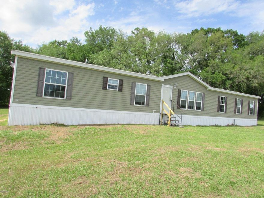 WOW... Look at this Beauty! This is the perfect home just awaiting you!! Located in Graceville just off Hwy 77 sits this 4 Bedroom 2 Bath DWMH with 1976 sq ft sitting on 3.50 acres!! Large Living Room plus family room! Open kitchen with lots of cabinets and breakfast bar! The master bedroom has a sitting area, and the master bath has a garden tub and separate shower! A split bedroom plan with 3 additional bedrooms! The 3.50 acres is cleared with a pole barn and a storage building. This home is listed to SELL and will NOT last long!! Call today for your personal showing!!