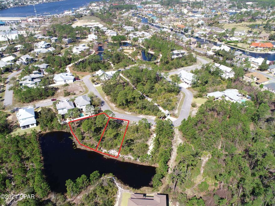 Price includes 2 lots, side by side, on a small pond in Martinique!  Martinique is a gated community in Panama City Beach with custom built homes in a lovely neighborhood setting. Enjoy a community pool, play area, pavilion, basketball court and walking trails. Close to great schools, shopping and dining, boating, marinas, St Andrew's State Park, and of course, the World's Most Beautiful Beaches! Come build your dream home and take advantage of LOCATION LOCATION LOCATION In Panama City Beach. Seller is licensed Florida Realtor.