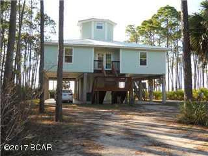 Spectacular views of St Joseph's Bay! This BAY FRONT home situated on 3.57 acres has 100 ft of water frontage. The foyer which opens into the living area has two guest bedrooms and an alcove with bunk beds for the little ones. The spacious living, kitchen & dining area are the perfect spot for families and entertaining. The kitchen has a large breakfast bar area for six. The stainless appliances include a GE Profile gas stove with double oven, built in microwave, etc. The sitting area is grouped around a beautiful 1841 antique fireplace with gas logs for winter evenings. There is a large covered porch and a loft upstairs with an open deck for watching incredible sunsets sets over the Bay. There is a large ground level area with a patio, shower, fish cleaning station, two storage areas with stairs to the 2nd level & 2 car parking.