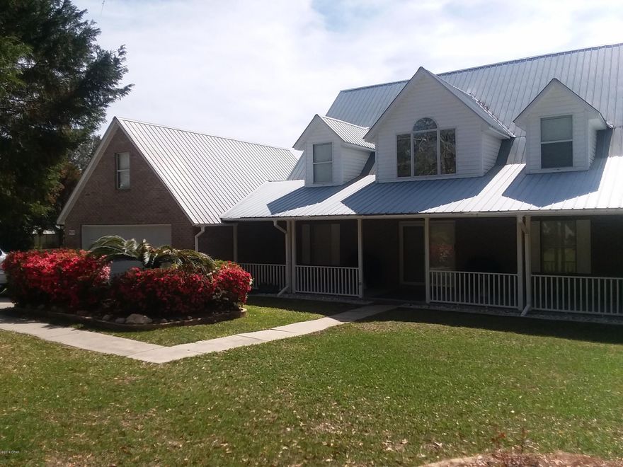 Lakefront Beauty on 1 acre! Leisure Lakes is in the country just 20 minutes North of Lynn Haven and is a GATED, PRIVATE community with paved roads. This home has over 2,500 square. ft. of living space and is a ONE Owner home! It shows pride of ownership and is immaculate! Enter onto your 48+ foot wide wrap around covered porch into the first level. A very large lakefront living room with electric fireplace and dining area all with incredible views of the crystal blue water and a white sandy beach. Fabulous NEW KITCHEN with cabinets,appliances, quarts counter tops, just perfect for entertaining! A large master bedroom is on the first floor with whirlpool tub, separate shower and walk-in closet. The bathroom has an updated vanity with corian counter tops and beautiful custom mirror to ma The vaulted ceiling in the living room has an opening to the loft between the two bedrooms. Upstairs there are two huge Guest suites both with his and her closets and dormer alcoves with built in window seats with storage feature. The garage has a separate side entrance in the back to be used for a Golf cart garage or workshop or additional garage. Plush landscaping with sprinklers and gardens adorn the yard. This home also includes one of the largest lake front screen porches one could imagine. The floating 30 ft. dock is included on the lot next door and some furnishings are negotiable. There are markers on each side of the lot depicting the property lines. Leisure Lakes offers amenities such as TWO spring fed lakes with boat ramps for fishing (electric motors only), waterfront swimming pool, pavilion with picnic tables and grills, beach with swimming area and raft, tennis courts, basketball and even a playground for the kids! Don't miss out on this rare opportunity! Please call for your private showing today!