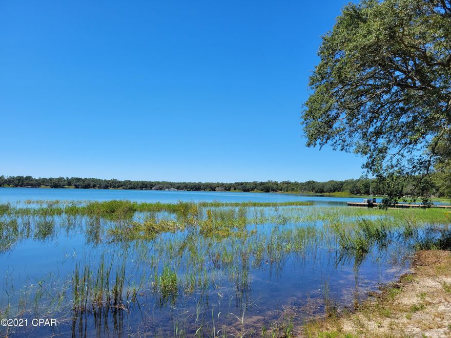 CURRENTLY UNDER CONTRACT SELLER ACCEPTING BACKUP OFFERS This gorgeous lot is on the big lake in Leisure Lakes gated subdivision. It has been cleared all the way down to the shoreline. Located on the east side of the lake, it is a great place to watch stunning sunsets across the lake. This is the only waterfront lot for sale on the big lake. Build your dream home here! It has some huge oak trees to provide some shade and beauty. At the front part of the lot is a huge oak tree that would be good for a rope swing. The subdivision offers plenty of recreation including a basketball court, tennis court, swimming pool, exercise room, rental kitchen, covered pavilion with men's and women's restrooms, boat launch, toddler playground and more.