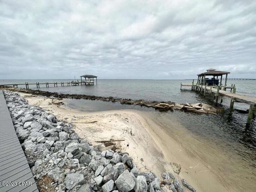 Here's your chance to build your dream home on the water with over 60 feet of waterfront! This small and quiet gated community of Clipper Bay is a hidden jewel in this area of Gulf Breeze. Located at Redfish Point with captivating views of the Bay, including Garcon Point Bridge and Three Mile Bridge. This improved lot is ready to go with water connection, sewer tap & power.