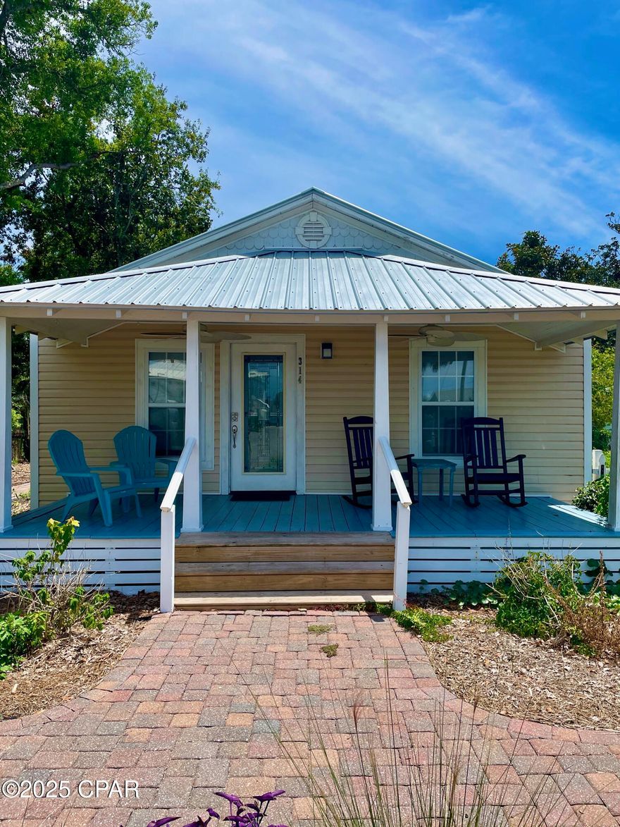 Discover the quintessential Florida cottage experience in this charming Port St. Joe retreat. Nestled within the sought-after short-term rental district, you'll be steps away from downtown's vibrant scene and the tranquil beauty of St. Joseph Bay. The cottage's interior is a showcase of character, featuring warm tongue-and-groove details and original hardwood floors. Recently renovated in 2023 with a new kitchen, bathroom, HVAC, and deck, it's move-in (or rent-out) ready. A pole barn and storage shed accommodate your recreational needs. This turnkey property offers both a delightful personal escape and a successful rental venture.