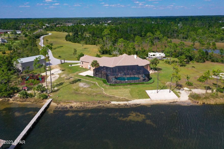 CURRENTLY UNDER CONTRACT, SELLER WILL CONSIDER BACKUP OFFERS' $450k+ in upgrades! 16+ Acres of WATERFRONT! HORSES? BOATING? RVs? If any of those catch your attention, you have the RARE OPPORTUNTY to OWN this incredible 4bedrm/4.5bath waterfront home! Fabulous sunsets can be enjoyed from the back porch. The newly refurbished pool includes new tile, sunshelf and pool loungers.  The screen surrounding the pool also covers the outdoor porches for bug free living! The dock, boat house with boat lift has been renovated to include water, elec and a sink for cleaning your fresh catch! 30x50 foam insulated garage/workshop w/two 12x14 garage doors easily accommodates 2 class A motorhomes or boats, tractors...or horses!  Beautifully designed play yard with jungle gym is perfect for kids or grandkids...The large open kit (w/fabulous views of the water) has dbl ovens, microwave, freshly painted cabinets, beautiful backsplash, large island (with vegetable sink) and the most stunning quartz counters!  Conveniently located just outside the kitchen is the outdoor kitchen! The wet bar has a wine cooler, ice maker and sink. Lovely Dimplex heating FP surrounded by stacked stone, is the focal point of the living room. Spend family time in the home theatre, especially painted for perfect viewing of your favorite movies. The elevated dining area has a dining table that converts to a pool table for more family fun! Lutron shades (controlled by your phone) in the MBR and living room keep the light out when needed. All windows have additional tint, new vanities in all the bathrooms, new paint, lighting, flooring and more...For a complete list of updates and amenities see the documents section of the MLS.  Owner is a licensed realtor. Age, sq ft, lot size, rm sizes are estimates. Please measure, if concerned.