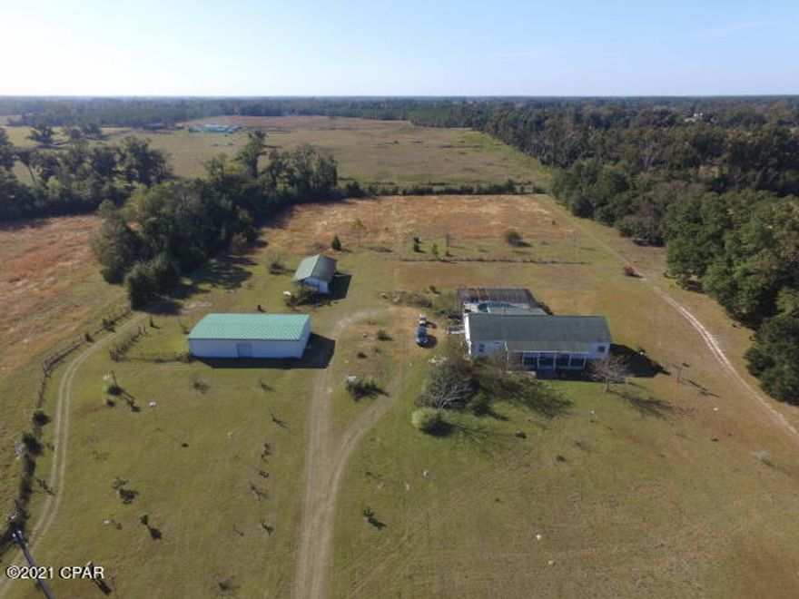 Under Contract - Taking Backups.   'CURRENTLY UNDER CONTRACT, SELLER ACCEPTING BACKUP OFFERS'.  39 Acres square with a 2088 sf modular home which includes the screened in heated inground poured concrete pool, 70x30 metal storage building with a bathroom and a small kitchen on it's own electric meter.  This property is located on a paved road in North Jackson county.  The property does have 2 septic tanks & one well.  Rocking chair front porch & a16x30 screened back porch with an attached deck for your BBQ grill.  Property is private which cannot be seen from the road.  Nice wooded buffer zone. Plenty of room for your horses & catttle.  Seller planted a row of producing blueberries and there's also a peach & pear tree. The house has a nice roomy kitchen with plenty of cabinets & counter space, large walkin pantry & stainless steel GE appliances.  Split bedroom floor plan. Plus more.  The outside vinyl siding is insulated.  Hotwater on demand.  HVAC replaced in 2019 to a Rheem Classic Series.  Florida Public Utilites. Average electric bill is $150 - $180.  Centurylink & Dish bundle package. 7 acres fenced around the house.  Pool has a Pentair ultra energy efficient pump, Rheem heater. Pool 5ft deep. Pex plumbing and there is undersink water filter and a filter at the well.  9ft ceilings. Underground electric to house.