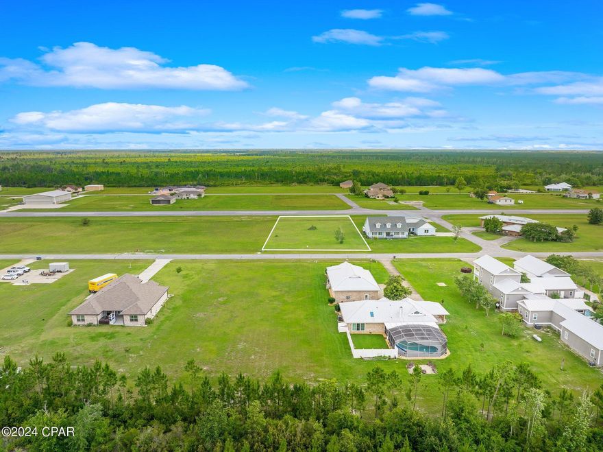 What an exciting opportunity to own a lot in private, gated Sandy Creek Air Park.  This .65 acre lot is perfect to build your custom home and airplane hangar.  Sandy Creek Air Park offers a 3200 feet paved private runway that is lighted dusk to dawn, has a green-white beacon and is designated by the FAA as 75L on the New Orleans sectional chart. There is also a clubhouse that is under remodel.  Conveniently located near Tyndall AFB, Panama City and the beaches of Panama City Beach, Mexico Beach and Port St. Joe Beach.  Don't miss this chance to live in a fly in/fly out community where you can taxi from your driveway right to the runway!  HOA fees are $650 per year which include the electronic entry gate, clubhouse and common area upkeep. You can also have your individual lot mowed for an additional $595 per year.