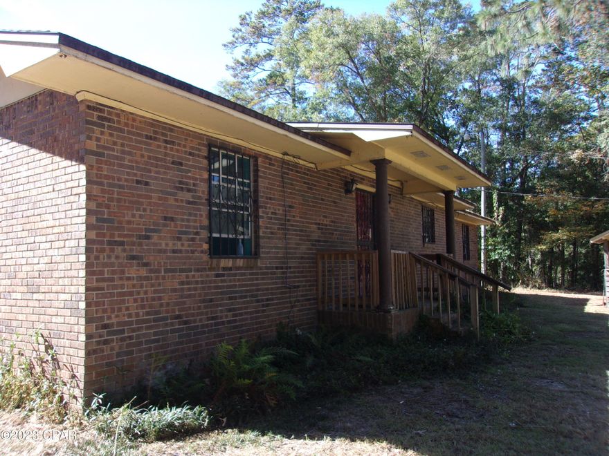 Great Fixer Upper on 2.5 Acres MOL. 3-bedroom 2 bath Brick home. Could be a 4 bedroom since it has a nice little playroom or TV room with an area that could be a closet.  Has a large country Kitchen with real wood cabinets, closet area for washer and dryer and plenty of room for a dinette set.  Large living room with fireplace and large dining area. No appliances but has an almost new hot water heater. Has large storage room/ pantry.  Outside you will find 2 attached carports, a large, nice storage building with a large deck and an enclosed lean too on the back, a brick grill pit, another storage building and brick flower beds. Lots of flowering bushes and plenty of room for a garden for the spring and for fall.  Located in the Dogwood Lakes area. Area has nice fishing lake and an 18 hole golf course. Home need work but fix it up and at least double it's value. A lot of house for the price so check it out today and reap the benefits.