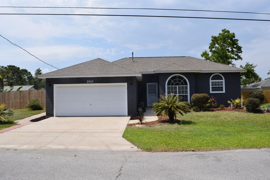Cute house with great curb appeal!  This contemporary style beach house was freshly painted inside and out, has a brand new architectural shingle roof, new privacy fence, and new air conditioning system. The raised ceilings create an open and airy feel. The living/dining area is open to the kitchen. All colors are neutral. The  flooring in the main area is new vinyl plank, the wet areas are tiled, and the bed rooms have new plush carpet. The large backyard has a privacy fence and a screened in porch.  Right across the street from the home is a pretty pond with beautiful foliage, giving this home a real charming appeal!