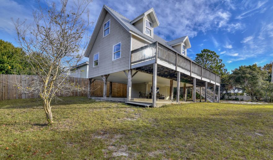 Price Adjustment! Within 1/2 mile to the World's Most Beautiful Beaches! This beautifully beachy decorated 3 bedroom 2 bath home has recently been upgraded with a brand new kitchen and new bathrooms. First floor contains the Master bedroom and Master Bath while the second floor includes a split floor plan. Enjoy reading a book while lounging on the deck that wraps around the entire front of the house or cool off under the covered patio downstairs. This would make a wonderful primary or secondary home. Don't let this opportunity pass you by!