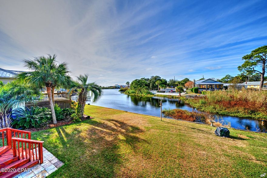 'CURRENTLY UNDER CONTRACT, SELLER ACCEPTING BACKUP OFFERS'

Unbelievable, 3 story townhome 1/2 block from the beach. Townhome offers 3 bedrooms, 2 baths in main unit, and full basement/studio apartment w/ kitchenette & bathroom. One bedroom is downstairs while the other two are on 3rd floor. Living area is nice and open. Features include breakfast bar, bay window, wood-like tile in living room and three sets of tinted sliding glass doors to large deck overlooking the lake. Upstairs master bedroom has sliding glass doors to another large deck overlooking the lake. Unit has a small view of the Gulf. Believe it or not, this home has a full basement (23x32) - half is finished and ideal for a game room or mother-in-law suite, while the other half is unfinished, perfect for kayak/paddle board storage and/or workshop. Gorgeous sunset view! Enjoy the serenity of PCB, the water and beautiful sunsets from your decks and/or relax on your dock.
