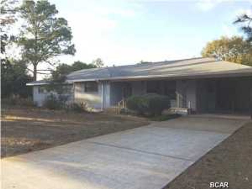 Sturdy well built large home on a corner lot. This sprawling home sits on over a half acre and has so much to offer. Outside, there is a large front porch and a huge deck off the back of the house. Aside from the two car carport (if parking back to back), there is a long driveway with plenty of room for boats and RV's. There is also a generously oversized two car garage with yet another driveway. The kitchen is large with both a dining area and breakfast area, lots of cabinets and counter space. In addition to the large living room there is a huge great room which could be modifed very easily to become a gigantic master bedroom if desired. Year built estimated and effective year built provided by Gulf County Property Appraiser is not reflective of actual year built.