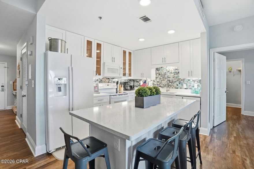 This exceptional first-floor residence offers the best of both worlds: calm lake views and easy access, all without the wait or hassle of elevators. From the moment you step inside, the coastal design and sophistication set this unit apart.

The beautifully updated kitchen is a true showpiece, featuring crisp cabinetry, upgraded countertops, modern appliances, and a striking turquoise backsplash bringing the Gulf's colors indoors. The open-concept living and dining space is light-filled and inviting—perfect for entertaining or unwinding after a day at the beach.

This unit offers two spacious bedrooms plus a stylish bunk room, ideal for guests or family. With the addition of a barn door, the bunk room easily functions as a third bedroom offering privacy, adding flexibility and value. The primary suite is a peaceful retreat, positioned directly on the lake with soothing water views that make mornings and evenings feel extra special.

Step out onto the large private balcony spanning the width of the unit to enjoy lake life and take in the nightly light show, visible both outdoors and from the comfort of the living area inside.

Beautiful design touches flow throughout the home, blending coastal charm with modern comfort. From the furnishings to the finishes, every detail reflects the essence of the perfect beach getaway.

Whether used as a primary residence, second home, or investment property, this first-floor unit with water views is a rare opportunity—where beauty, convenience, and coastal elegance come together seamlessly.

As part of a large resort, you'll have access to world-class amenities, including the newest addition of 810 Billiards & Bowling as fun for the whole family on property, five pools (one zero-entry, heated, and a dedicated kiddie pool), two hot tubs, a state-of-the-art fitness center, and a putting green. Enjoy the convenience of multiple onsite dining options and a boardwalk that showcases a stunning nightly water fountain light show. Don't miss this opportunity to own a piece of paradise with solid rental returns and endless coastal charm! All measurements to be verified by buyer if deemed important.