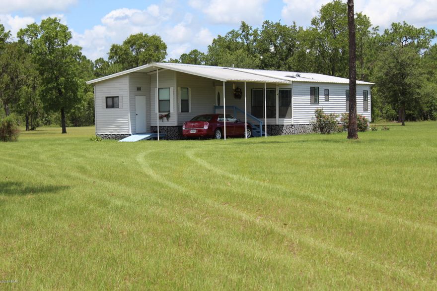 If you are looking for mini ranch or just want more room, take a look. Well maintained manufactured home on 15 nicely landscaped acres in Western Calhoun County. Minutes from Hwy 231 and approximately 40 miles to Panama City. Property has flowering plants and fruit trees. Enter into foyer then large living room with built in cabinets. Next is the eat in kitchen with skylight. Home features  split bedroom plan, large living room, walk-in closet in Master bedroom. There is a screened porch off the living room to enjoy the peaceful mornings or evenings.  Home is equipped with RV hookup, attached one car carport and utility room. Large 30 x 40 metal barn to store tools and equipment- could easily add horse stalls. This property has many possibilities, call for a showing today
