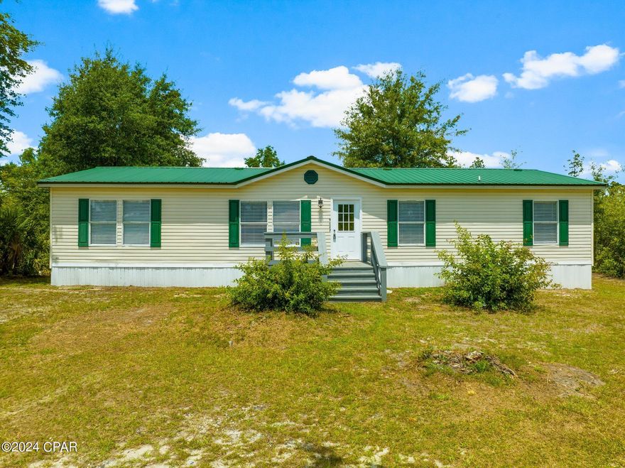 UNDER CONTRACT, SELLER WILL CONSIDER BACK UP OFFERS. A thoughtfully updated 4-bedroom, 2-bathroom manufactured home offering 1,620 square feet of modern, comfortable living space. Nestled on an approximately 1-acre lot tucked away in the pines, this property is a hidden gem, perfect for those seeking a retreat with all the conveniences of contemporary living. One of the standout features of this home is the extensive recent updates and renovations, ensuring a move-in-ready experience. As you approach the property, you'll immediately notice the fresh, new exterior paint and drywall that provides a sleek, modern look. Step inside, and you'll be greeted by an inviting and spacious interior that has been updated to offer both style and functionality. The home is equipped with a brand-new A/C unit and insulation, ensuring that you can enjoy modern comforts without any worries. The new carpet adds a touch of luxury and warmth to the living spaces, making each room a cozy haven. The heart of the home, the kitchen, has been completely renovated to meet the needs of the modern homeowner. The kitchen features all-new cabinetry, offering ample storage space for all your kitchen essentials. The granite countertops are both elegant and durable, providing a sophisticated touch while ensuring long-lasting quality. No kitchen renovation is complete without top-of-the-line appliances, and this home does not disappoint. The kitchen has new stainless steel Whirlpool appliances, including a refrigerator, oven, microwave, and dishwasher. These high-quality appliances are designed to make cooking and cleaning a breeze, allowing you to spend more time enjoying your home and less time on chores.  The living room is a bright and airy space, with windows that let in plenty of natural light. The home features three generously sized bedrooms. The primary bedroom has an en-suite bathroom for added privacy and convenience. The additional bedrooms are perfect for children, guests, or even a home office, providing flexibility to suit your needs. Additional updates to the home include new front and back doors, as well as interior doors, lights, fans, fixtures, and electrical updates. Don't miss out on the opportunity to make this property your new home. Schedule a viewing today with a REALTOR today. If important, please verify all information and measurements.