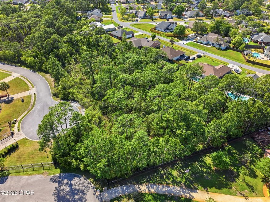 Located in the heart of the gated Trieste community, this nearly 3/4-acre premium lot is one of the largest buildable homesites available and uniquely positioned across two private cul-de-sacs, offering exceptional space and privacy. Surrounded by beautifully designed Mediterranean-style homes, the property sits in an ideal interior location within the neighborhood, providing a quiet setting while still being just minutes from the best of Panama City Beach living, including Pier Park shopping and dining, a public boat launch, scenic hiking trails, and golf at Legacy Golf Club--making it the perfect place to build your dream home near the beach. All dimensions are approximated and should be verified by the Buyer.