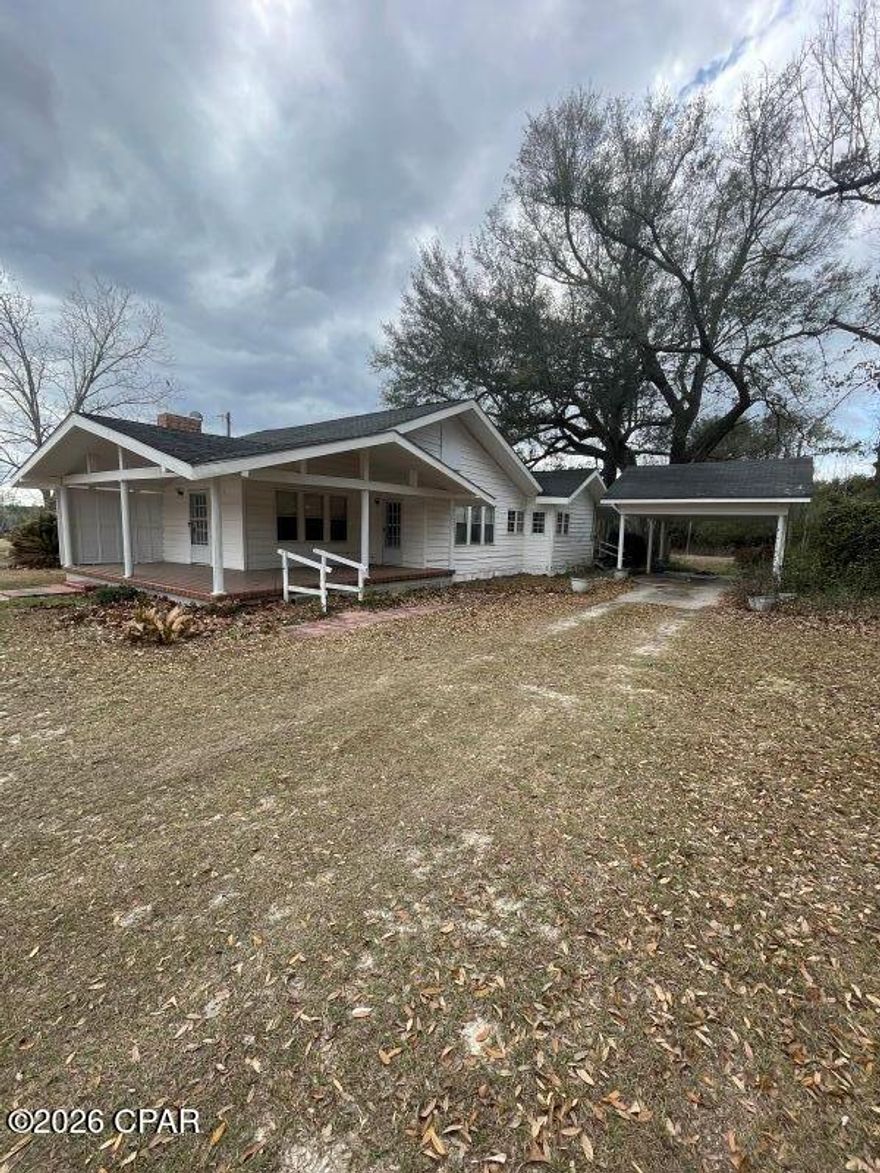 $249,000. If the country is calling you, check out this comfortable 3-BR, 2-bath home on 2+ acres just 3 miles to Chipola River boat launch for good fishing and/or boating activity! With 1759 sq. ft. of heated/cooled living space, this 1950 home has had remodels and updates over the years. The L-shaped porch faces the paved county road and is 8' x 14' on one side and connects to an 8' x 24' front porch. Kitchen has plenty of cabinets and is equipped with new GE stainless stove and refrigerator, and a white dishwasher. Wood paneled walls grace the kitchen, breakfast nook, utility/storage room, and one of the BR's, while the paneling in 2 BR's and living room are painted, and the dining room has wallpaper plus a nice built-in cabinet with drawers and shelves for storing and/or displaying china. Formal dining room and living room are separated by pretty French doors and the living room has a brick fireplace, flanked with bookshelves on either side. The master BR suite has 2 closets and a very spacious bathroom. This country gem is located just 8 miles from Blountstown and about 35 miles from Panama City for shopping, medical, and the Gulf Beaches! Add this one to your list of homes to view... you'll be glad you did! $249,000.