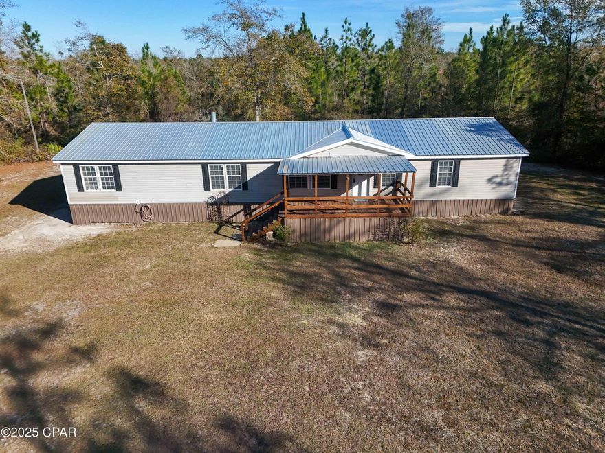 This large, well-maintained mobile home offers over 2200 sq ft of living space, providing ample room for your family to grow and thrive. Situated on nearly 2 acres of land, this property is a perfect blend of privacy and convenience, with just a 30-minute drive to the city limits of Panama City, Blountstown, and Marianna.

The home features a brand new roof, hot water heater, metal skirting, and newly installed ductwork. The 5-ton HVAC system ensures year-round comfort. You'll also enjoy the convenience of a washer and dryer already in place.

The spacious master bedroom is a true retreat, complete with a built-in overflow room/study—ideal for a baby crib, office, or a quiet reading nook. With two generous living rooms, there is no shortage of space for relaxing or entertaining.

Outside, a 32x36 pole barn provides ample storage for vehicles, equipment, or hobbies, adding even more value to this already impressive property.

With all of these features and the location just minutes from key towns, this home is a must-see for anyone looking for both space and accessibility in a peaceful setting.