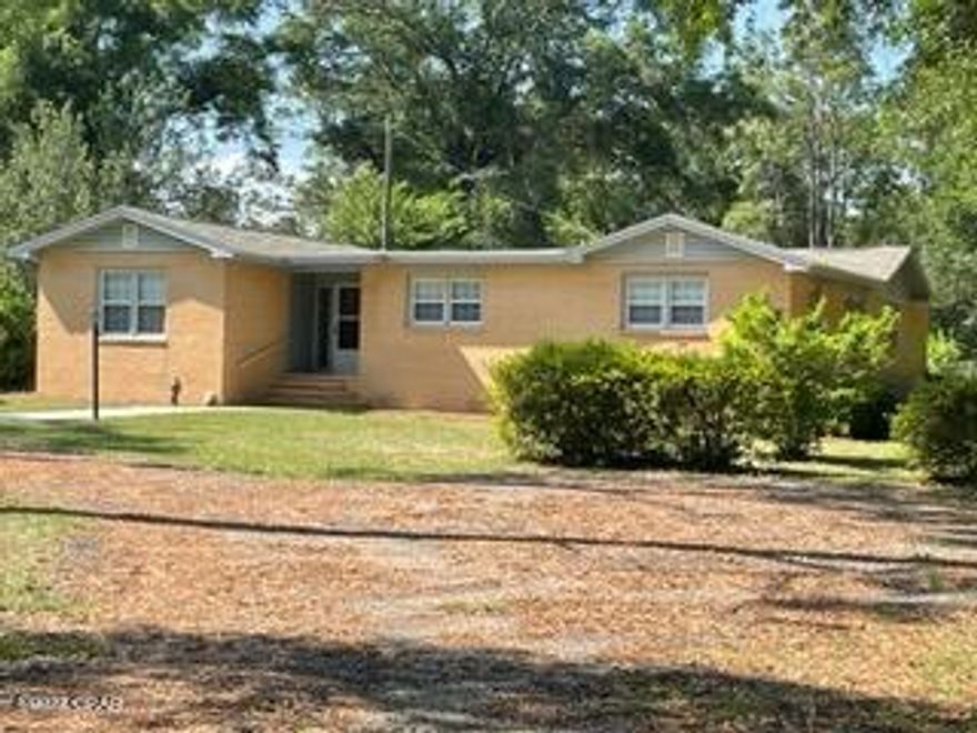 $289,900. PENDING CLOSING. This comfortable and spacious country home sits on 1.25 acres, with an additional 1.05 acres that will also convey with the sale. The vacant 1.05-acre parcel has water, septic, and power hook-up for anyone wanting to place a mobile home or any other building on this part of the property. Brick home was built in 1962 and offers 2,196 s.f. of heated/cooled living space, to include 4 BR's, 2 baths, living room, kitchen (with range, refrigerator, and baking oven), dining area, den, laundry (with washer & dryer), and library/office off the master bedroom. New roof installed 12/2021 has a limited warranty that transfers with the home. CHA system has been maintained annually, was serviced on 4/27/22, and received a good report. Two bedrooms and hallway still have the original hardwood floor, but most of the flooring is laminate vinyl plank, with ceramic tile in both bathrooms, and carpet only in the living room. The floor plan has 2 BR's on each side of the house, with a bath between each of the BR's. Both bathrooms have handicap accessible showers with seats, but no tubs. The current security system service can be continued if new owners desire. (Security company information will be provided if needed.) Termite bond is currently with Paul's Pest Control, and this bond is transferrable as well, if new owners choose to continue the service. Outside is a frame storage building or workshop with concrete flooring, as well as a small building that houses the well pump. The 18' x 36' vinyl liner needs replacing, but the pool is selling  "as is". The 1.25-acre parcel which the home sits on has electricity, septic tank, a well and also Talquin water.  This great location is quiet and rural, yet just 25 minutes to Tallahassee for work, hospitals, shopping, or entertainment! Well-landscaped and well-established yard has too many flowers, trees, and shrubs to name! If you're looking to escape to the country to have some space around you, this 2.30 acres with comfortable home, pool, and more may be just the place for you! PRICE REDUCED TO $289,900!