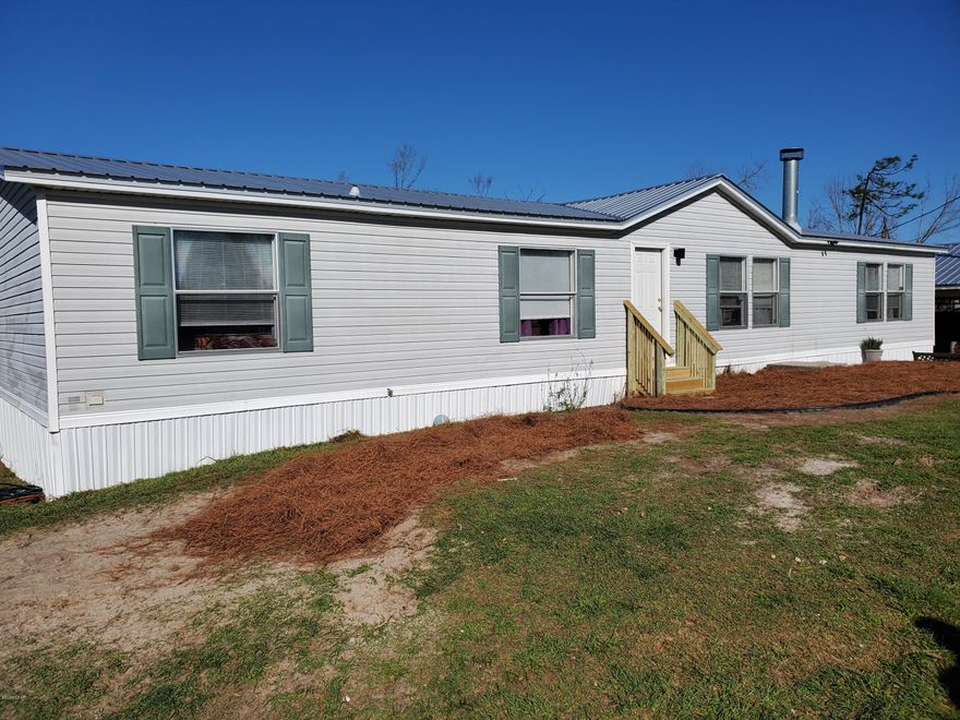 CURRENTLY UNDER CONTRACT.  SELLER IS ACCEPTING BACK UP OFFERS. New On The Market!! Beautiful 3 bedroom 2 bath home on just over an acre! Property is completed fenced with a stocked pond. New roof in 2019! Enter into an Open concept floor plan that is extremely spacious. Kitchen is open to the living space and offers stainless steel appliances and a pantry. Home has a formal living room with a wood burning fireplace and a beautiful den that has French doors to lead out to the back porch, perfect for entertaining family and friends. Split floorplan gives additional privacy to a very roomy master suite that boasts double vanities, separate shower, and a jacuzzi tub. Both guest rooms are nice sized. 24x24 carport with 24x24 Shop. Located in the Bayou George area 5 minutes from public boat ramp on Deer Point Lake and 10 minutes from Econfina Creek.Shop is wired 110 and 220. Water is plumbed to shop. 
 Smart tv in den and master bedroom convey.