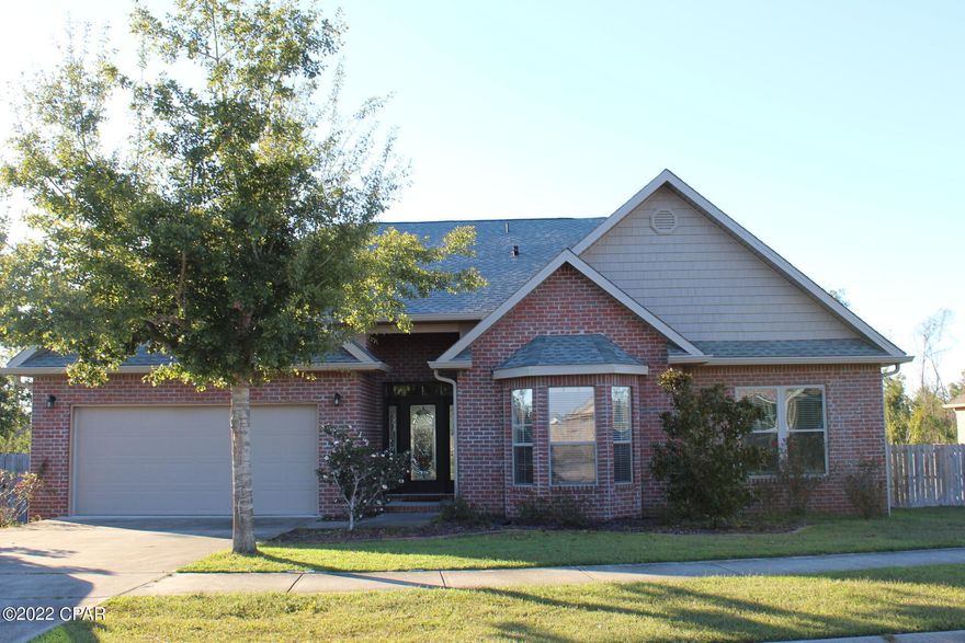 CURRENTLY UNDER CONTRACT, SELLER ACCEPTING BACKUP OFFERS 'Welcome to the popular Magnolia Hills Subdivision. Very desirable neighborhood.  This is a very spacious home with vaulted ceilings & electric fireplace in the living room.  Tray ceiling and crown molding in the formal dining room, and master suite. Features wood flooring throughout with tile flooring in the wet areas.  Master suite has private door leading to the covered patio. Master bath has double vanity with granite countertops, garden tub w/separate shower, and walk-in closet. Large eat-in-kitchen with granite countertops, plenty of cabinetry, plus a pantry. The covered patio area, is ideal for  the family BBQ's, and entertaining.  Spacious backyard, plus storage building for tools and equipment.  Convenient to Panama City,