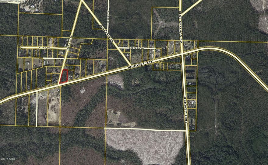 Convenient corner parcel, 1.7 acres at Hwy 388 and John Cox Rd. Great potential for your building, residential or light commercial. Owner financing also available.