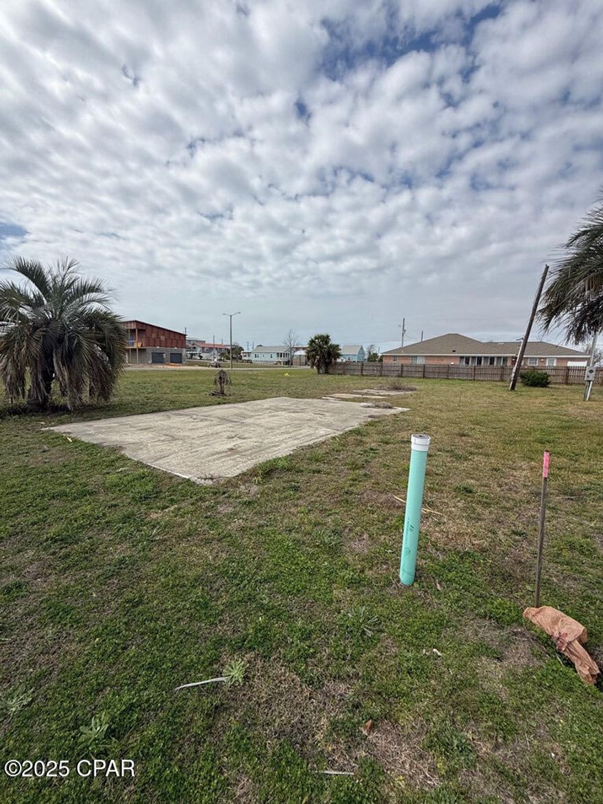 Corner lot located approximately 800 feet from the beautiful, sugar white sands beach with dedicated public access. This X flood zone lot was a former homesite and already has water and sewer taps paid. There are also some established palm trees, an existing driveway, and electric stub out. Many options for building as the X flood zone designation allows one to build on grade if desired. Quiet neighborhood with a nice boulevard (Florida Ave) for added privacy. Priced to sell and will not last long.