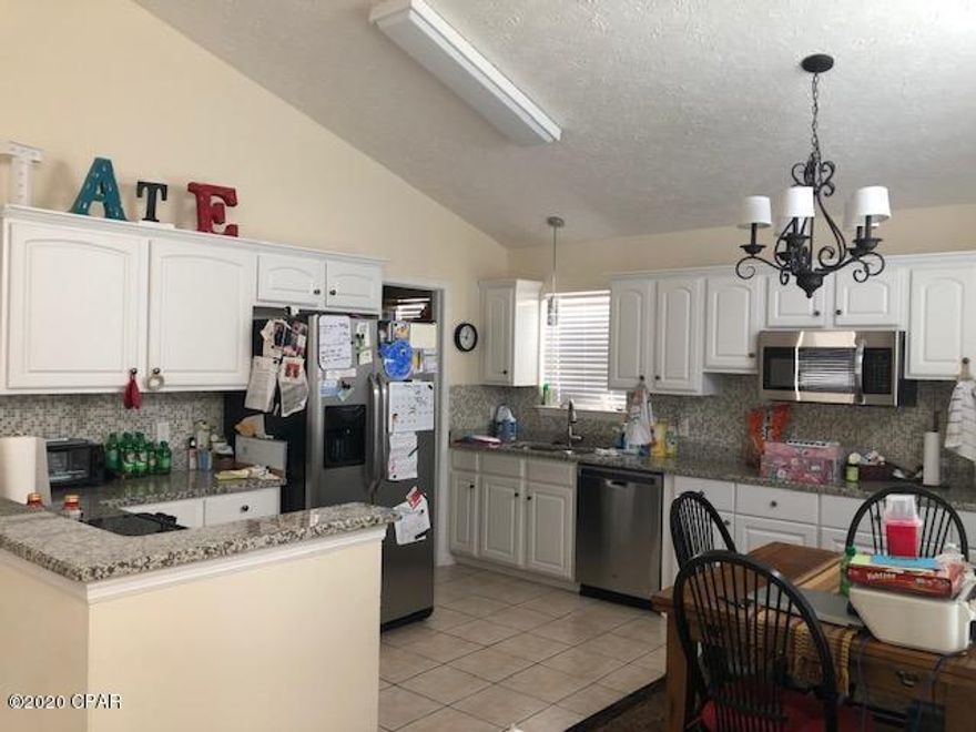 Currently Under Contract. Seller taking Back up Offers. Charming 3 Bedroom, 2 bath home located in established family friendly gated community walking distance to beach, pier, restaurants, water park, gym, & more. Close to senior center & library. Community offers 2 swimming pools & playground. large eat in kitchen is fully equipped with stainless steel appliances & granite counter top. Separate laundry room with washer & dryer included. Newer water heater and central heat/air plus solar roof  panels.  Cameras front and back door entrance. All measurements are approximate. Central Heat/Air, Water Heater, appliances are all 2 years old or less. Seller states electric bill is only $25.00 per month for current usage.