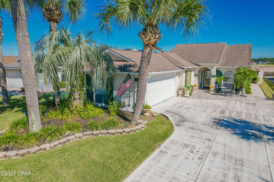 CURRENTLY UNDER CONTRACT, SELLER WILL CONSIDER BACKUP OFFER. Treat yourself to this meticulously maintained 3 bedroom 2 bathroom home in the highly sought after neighborhood of The Glades. With over 1,750 square feet of comfortable living space, this home was designed for entertaining as well as peace and relaxation. Airy walkways lead into the heart of the home, the living room with a cathedral ceiling and warm, genuine Toffee Oak wood flooring that continue throughout. The kitchen features marble tiling, and plenty of kitchen and counter space, all leading to a cozy kitchen nook (Additionally, the kitchen features a 2023 Frigidaire Refrigerator and a 2018 Commercial Grade InSinkErator). You'll love the primary bedroom with two walk in closets, and an en suite bathroom featuring a jacuzzi tub, full glass shower and double sink vanity. The additional two bedrooms have plenty of room for sleep and study, and are conveniently located near the second full bathroom. Step outside into the open-air, marble tiled patio and you'll dream about all the friends and family you'll have over to visit your new oasis. The fully screened lanai and the spacious patio embraces the signature Florida Coastal style. Nestled in this oasis is a 10,000-gallon inground, gunite pool. The pool is surrounded by paver walkways and enclosed in a newly installed pool cage. In addition the home features a large laundry room with a sink, a Rigid brand generator hardwired for the home with back-up electrical source, and a 2 car garage. This home is less than a mile from public beach access #39 on the GULF OF MEXICO and a short distance to Publix, Pier Park shopping, local restaurants, and the Navy Base. This home has it all and is a must see!