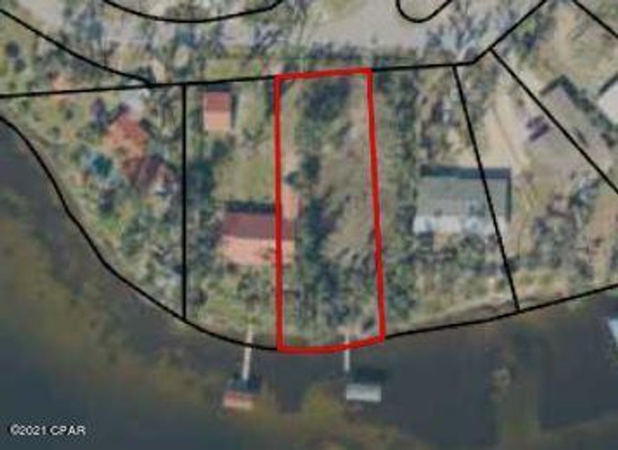 This lot is High and Dry. No Flood insurance required. There is a landing at waterfront.  Owner removed home with intentions of Building, but purchased another home instead.  There is a damaged dock and lift on site. There is also a boat house.  Easy access to Shell Island .