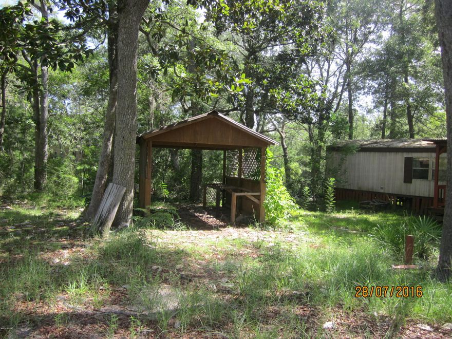 Mobile home located in Steelfield Fish Camp.  Sea wall and deck.  Covered boat storage.  Home needs works, but has the potential of being a great Fish camp.