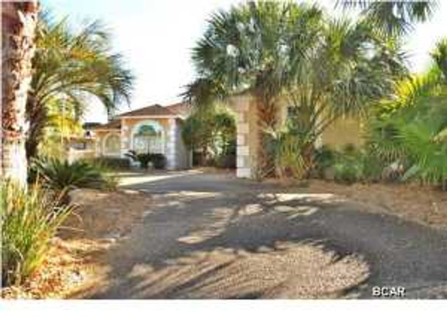 This is a gorgeous Bay Point canal home that sits at the end of Trout Dr. on the Cul-de-Sac. You drive into a circular driveway surrounded by tropical landscaping and lots of palm trees. This 3-bedroom, 2 1/2 bath home also has an extra room which makes an ideal office or library, and could even be utilized as a small 4 th. bedroom. The modern construction offers 10-foot ceilings throughout the house with x-large crown moldings, large and numerous 6-foot windows with transom windows overhead to let in all the natural light and several large arched windows. Large 18' diagonal tile throughout. Starting with the kitchen you have a big wide open cooking area with double ovens and gas range and plenty of cabinetry. The kitchen opens up into a nice breakfast area and family room which all