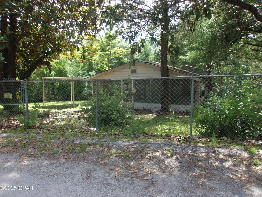 CURRENTLY UNDER CONTRACT, SELLER WILL CONSIDER BACKUP OFFERS' This charming fixer-upper presents an incredible opportunity for those looking to create their dream home in a serene rural setting. With three spacious bedrooms and one bath, plus two bonus rooms, the potential for customization and expansion is limitless. The inviting screened-in porch offers a perfect spot to relax and enjoy the peaceful surroundings, while the two carports provide ample space for vehicles and outdoor equipment. Situated on five expansive acres, you'll have plenty of room to explore, garden, or simply unwind in nature. Additionally, being just 30 minutes away from Panama City Beach, you can easily enjoy the sun and surf of the world's most beautiful beaches whenever you desire. This property is a diamond in the rough, waiting for the right buyer to breathe new life into its classic tongue-and-groove walls and transform it into a cozy retreat. With a little vision and effort, it's a chance to invest and save on a property that offers both space and tranquility. Don't miss out on this unique opportunity!